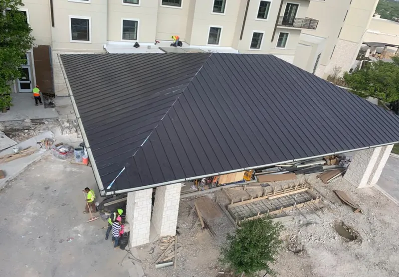 Metal roofing installation team working on a commercial building in Apollo Beach